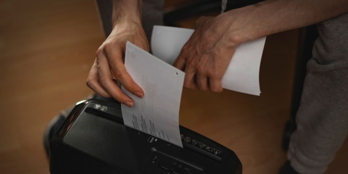 Putting paper into a shredder