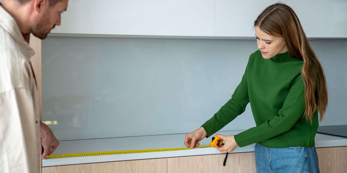 Person measuring worktop