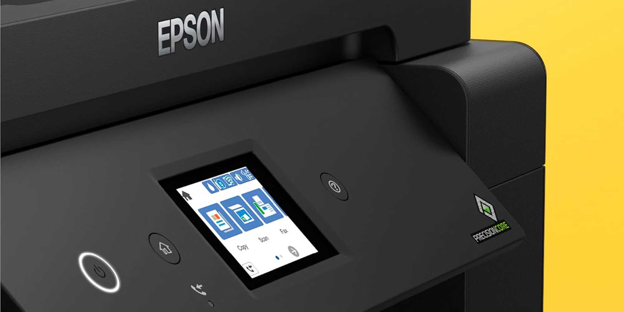A Canon printer producing a print of a colorful landscape with green trees and an aurora in a modern office setting.