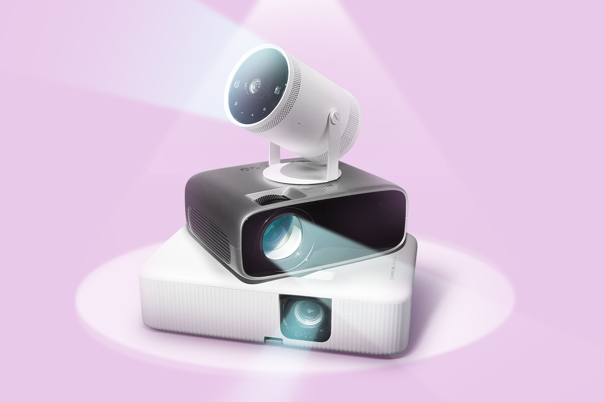 Three projectors stacked on top of each other, emitting light beams against a soft lavender background.