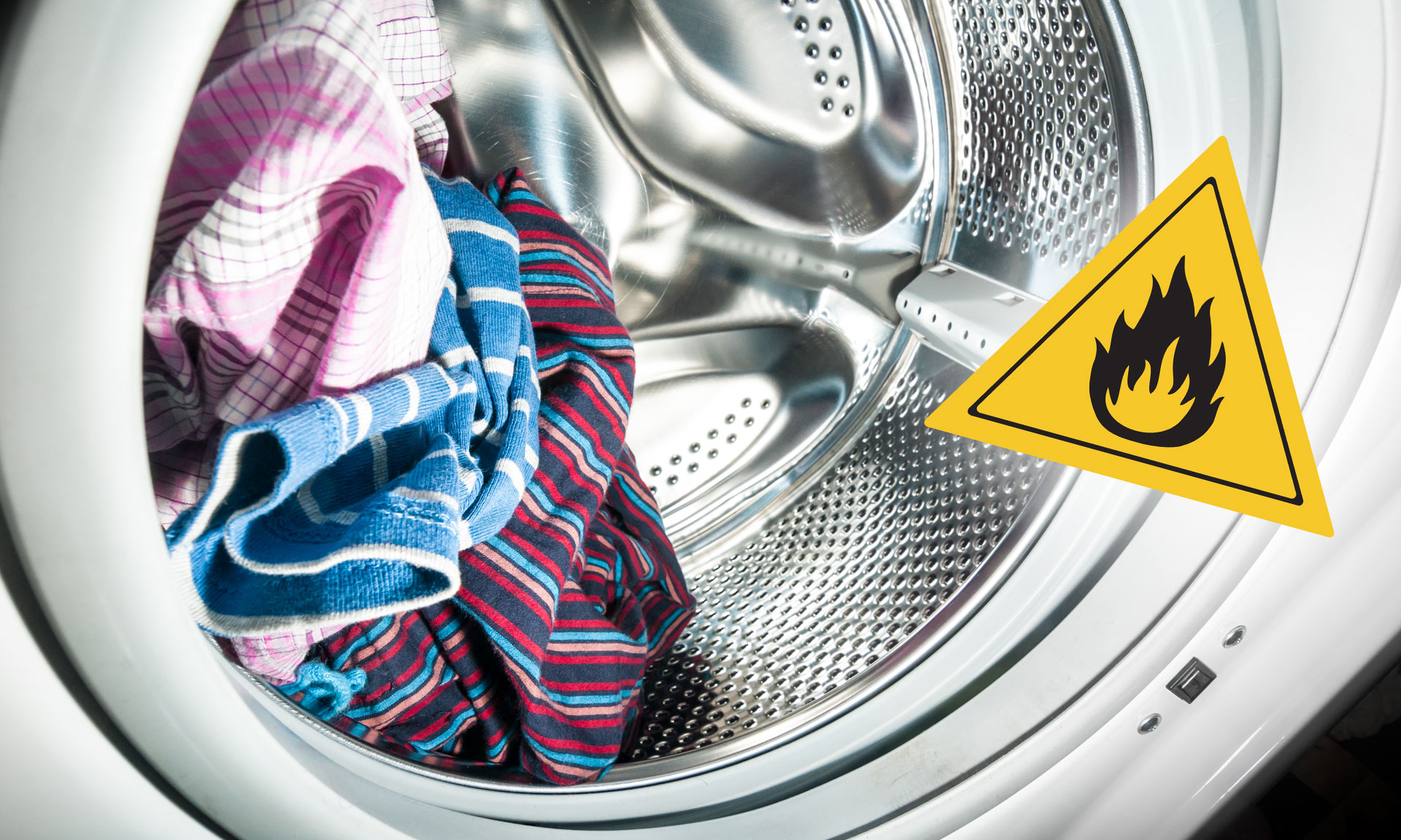 A washing machine drum with colorful clothes inside and a warning sign depicting a flame, indicating fire hazard.